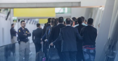 a group of people walking with luggage